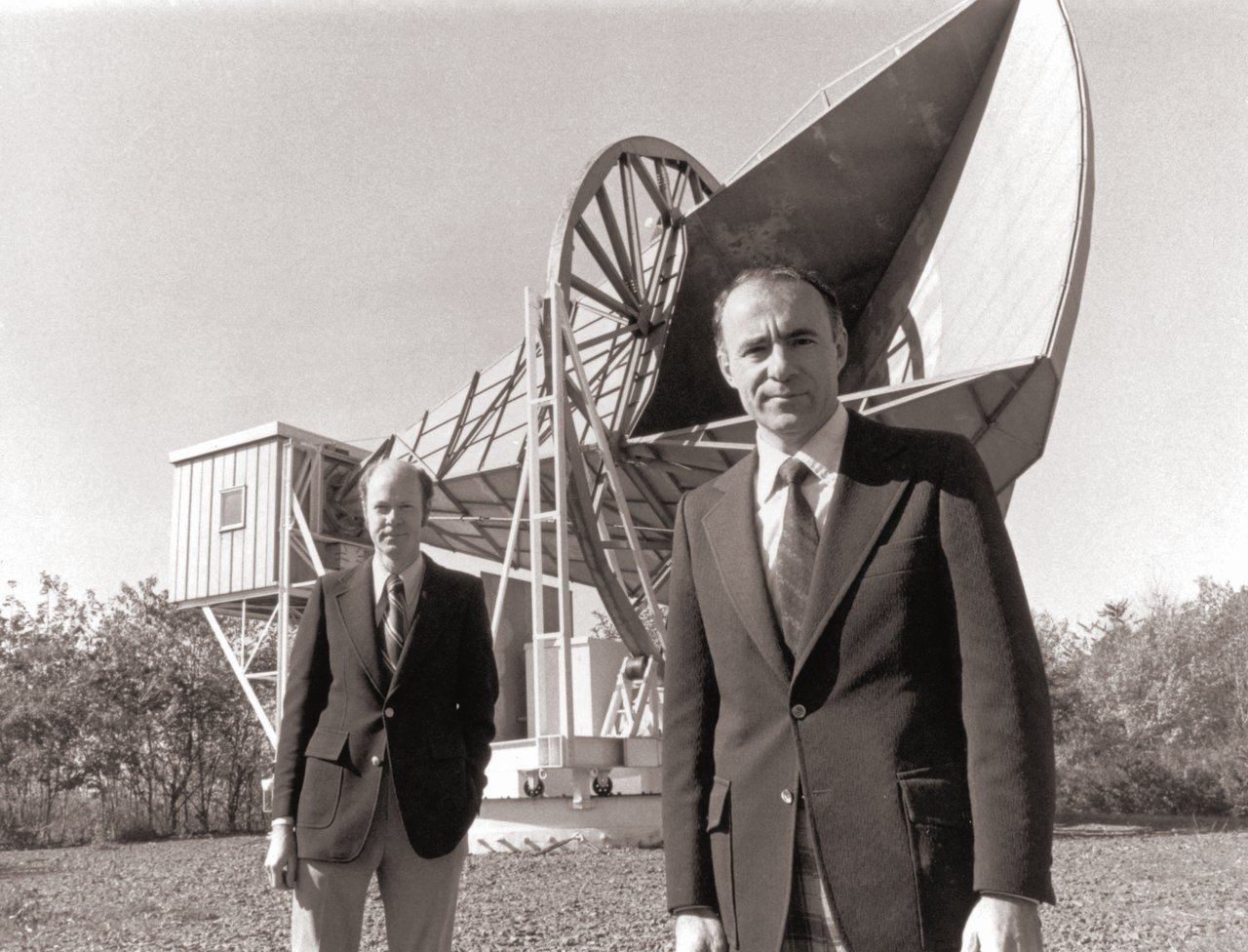 Os cientistas Robert Wilson e Arno Penzias posam à frente da antena que captou a radiação cósmica de fundo. Imagem: National Park Service